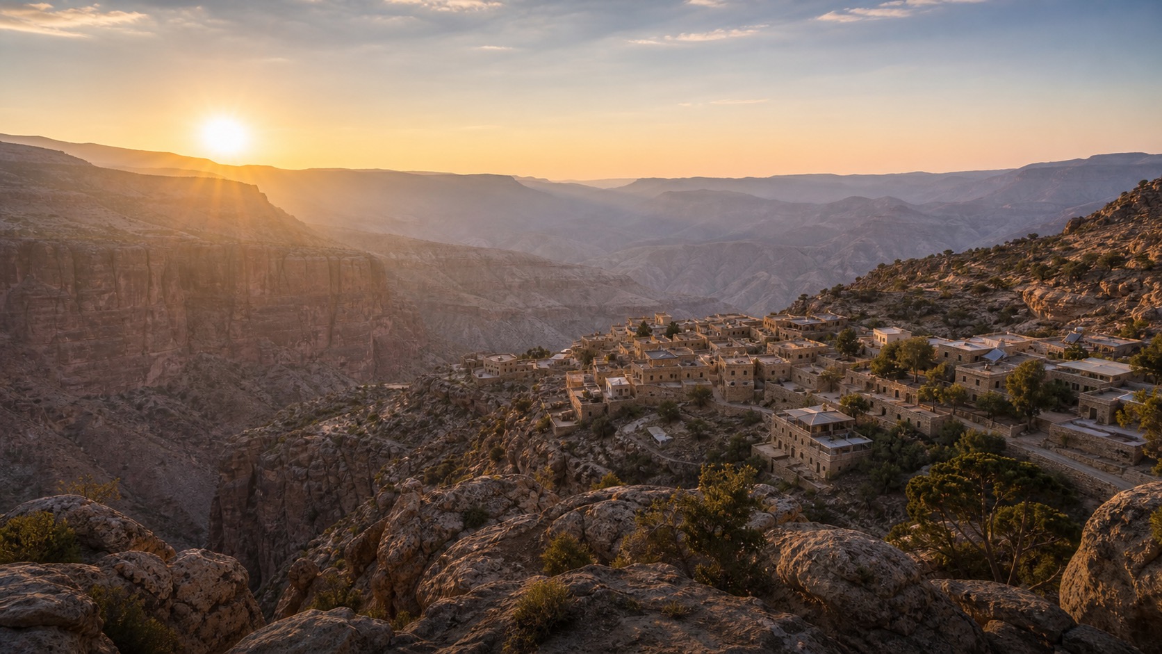 Dana Biosphere Reserve village and canyon cliffs at sunrise
